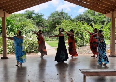 Hooikaika-Partnership-Ohana-Fes-2023-6-ladies-wearing-dresses-and -flowers-on-their-head-showing-Hula