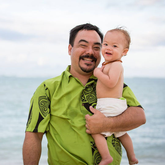 Ho'oikaika-Partnership-Happy-Jeremy-and-baby-Kai-dad smiling and holding baby